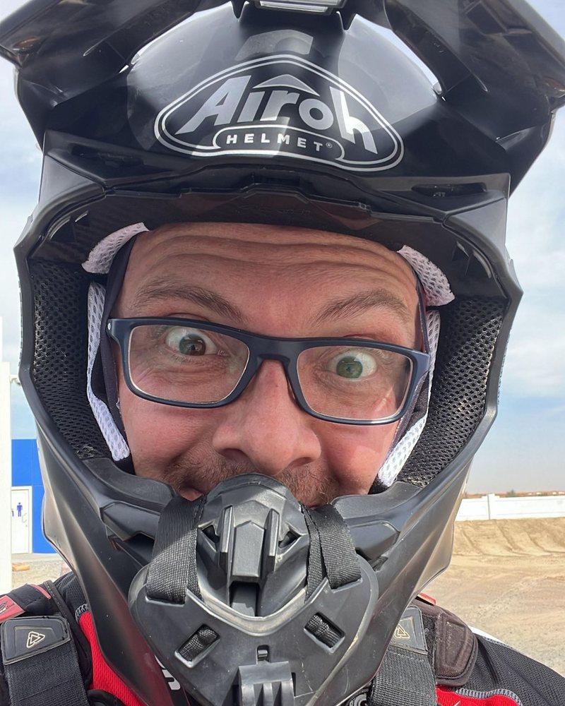 Luca pulling a wide-eyed face inside his helmet