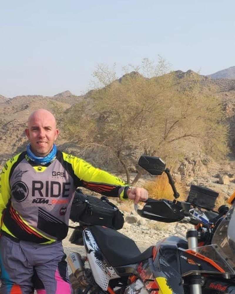 Martin standing next to his KTM in a wadi